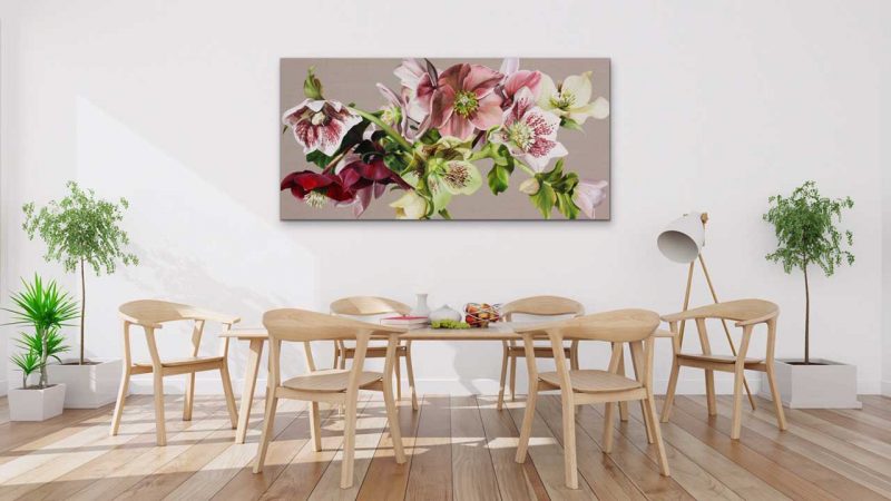 Canvas print of pink and white and green hellebores on linen background on a wall in a dining room. Painting by UK floral artist Sarah Caswell