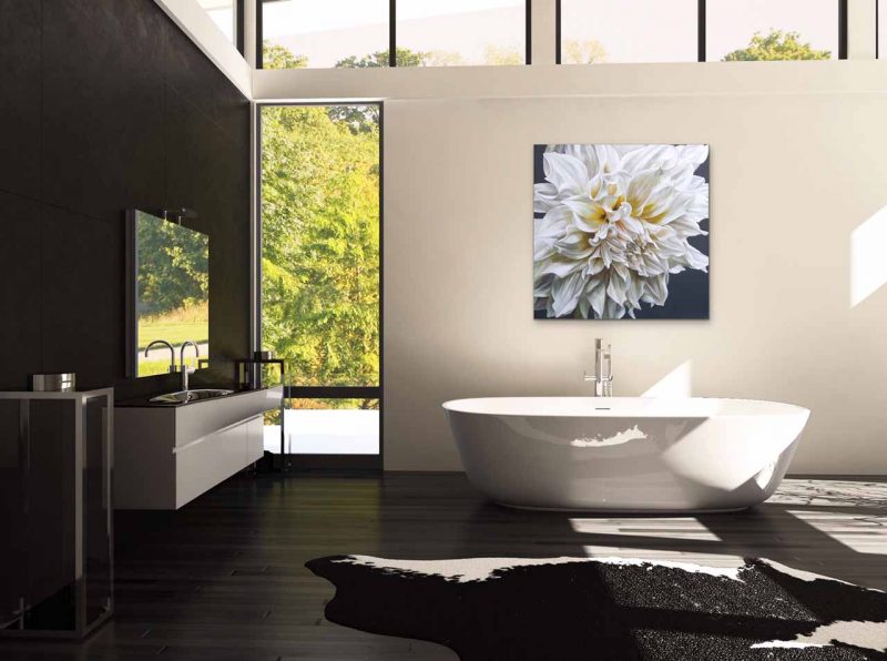 Canvas print of a white dahlia on dark background on a wall in a bath room. Painting by UK floral artist Sarah Caswell