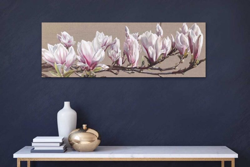 Canvas print of pink and white magnolia on linen background on a wall in a room. Painting by UK floral artist Sarah Caswell