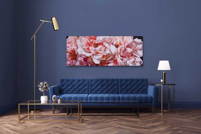 Canvas print of pink, coral and white roses on dark background on a wall in a living room. Painting by UK floral artist Sarah Caswell
