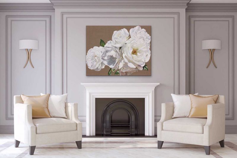 Canvas print of white roses on linen background on a wall in a living room. Painting by UK floral artist Sarah Caswell