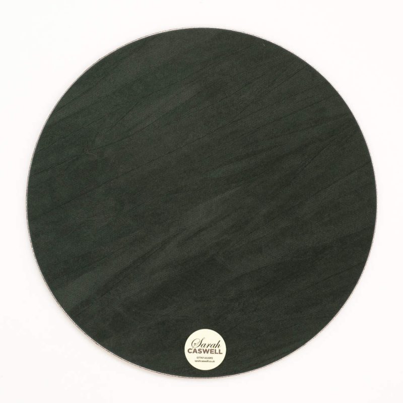 Green baize backing of round melamine tablemat