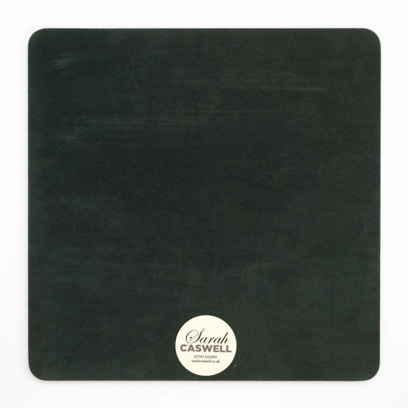 Green baize backing of square melamine tablemat