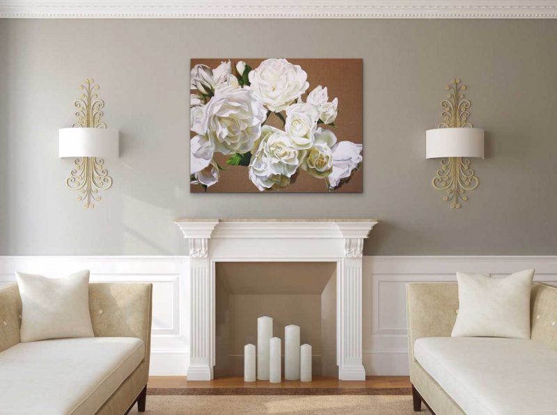 Canvas print of white roses on linen background on a wall in a living room. Painting by UK floral artist Sarah Caswell