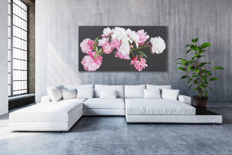 Original acrylic painting on brown background by Sarah Caswell of pink peonies in bright sunshine. Shown in a Living room setting.