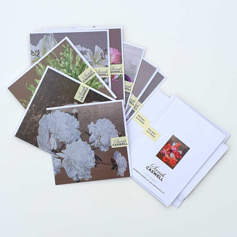 Selection of greetings cards and envelopes secured with a removable sticky label